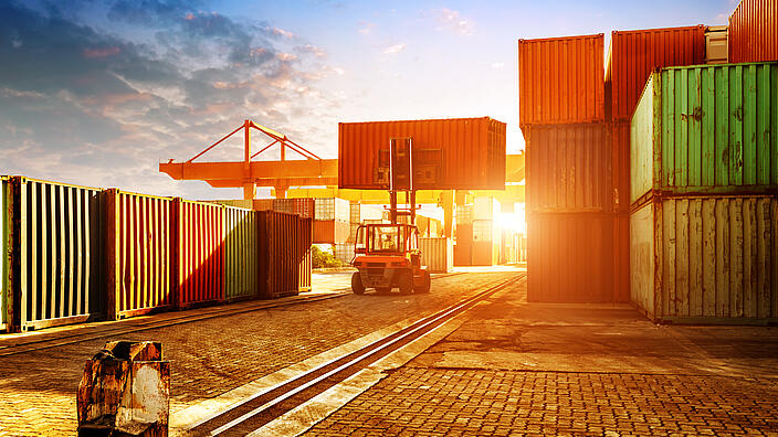 When the container terminal at dusk, work cranes and forklift