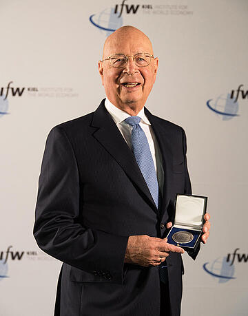 Klaus Schwab showing his medal