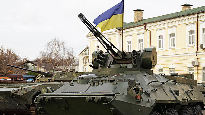 Army troops transporter and tank with Ukrainian flag, Ukraine