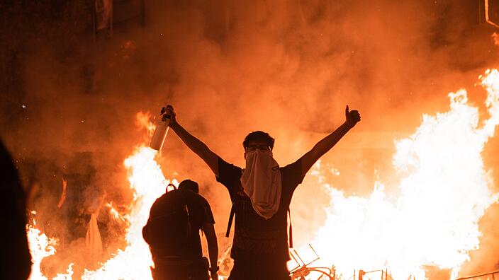 Chilean protesters in front of fires