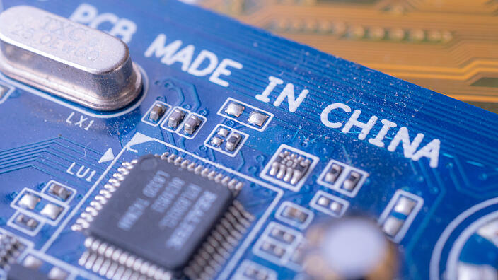 Made in china tag text on blue computer main board circuit