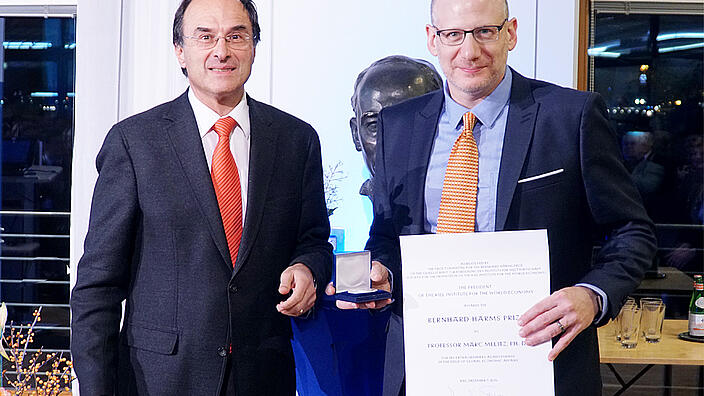 Snower and Melitz presenting certificate
