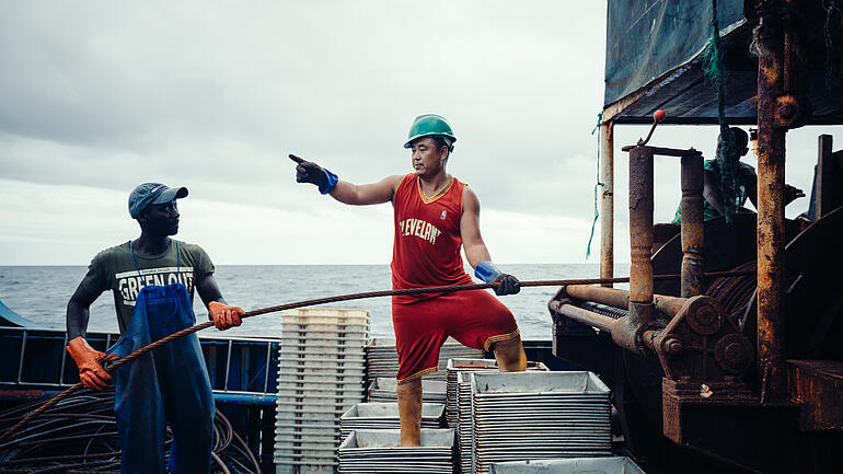 Two workers on a fishing boat