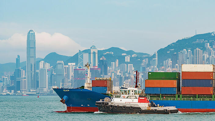 Cargo ship in Victoria Harbor of Hong Kong city