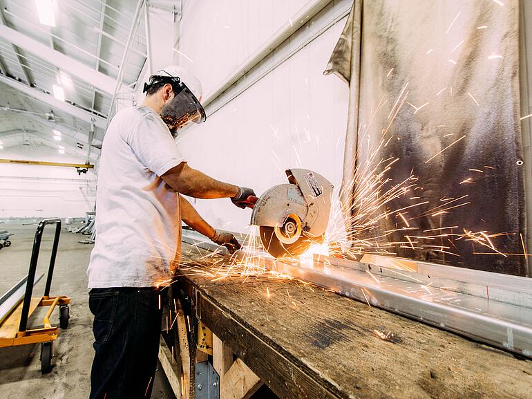 A welder working on a steel beam