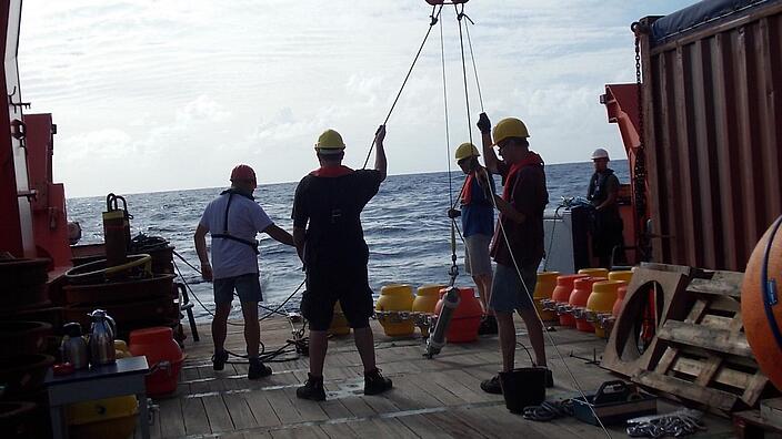 Workers on a ship ready to release buoys