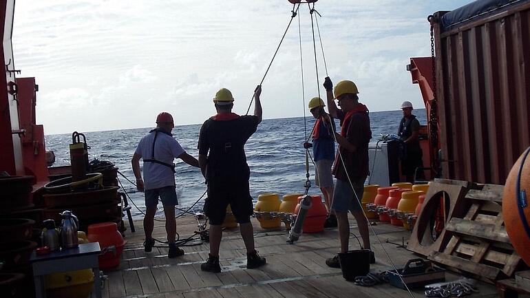 Workers on a ship ready to release buoys