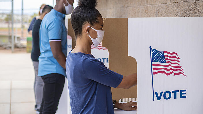 People in voting booths during US elections 