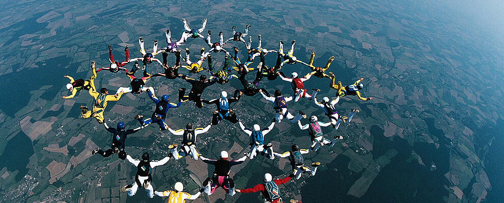 Skydivers forming a circle mid-air