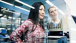 Global China Conversations Teaser Two women seen through a window discussing something