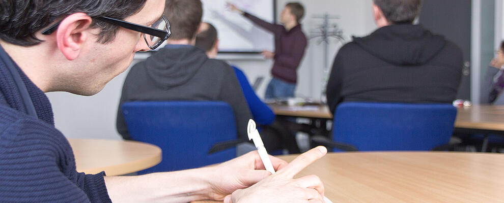 Attendee taking notes during a seminar