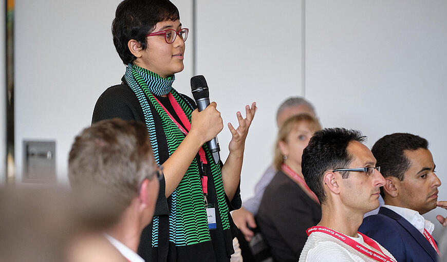 Woman in audience poses question