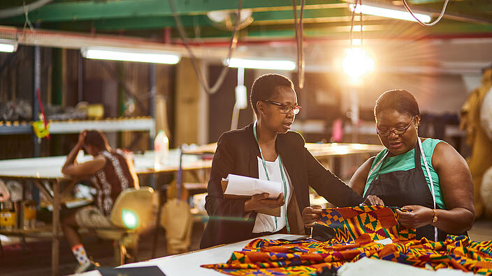 mature african business woman sewing factory