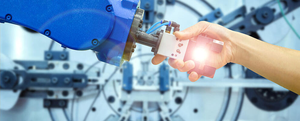 Industrial robot handshake with human on relationship for working on industrial manufacturing in concept industrial 4.0, on flare filter and blurred machinery working on blue tone background