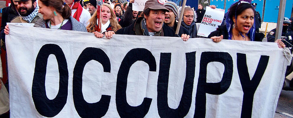 NEW YORK - DEC 12: Unidentified Occupy Wall Street protesters march to protest Goldman Sachs on December 12, 2011 in New York City, NY. Protests against the financial system took place nationwide.