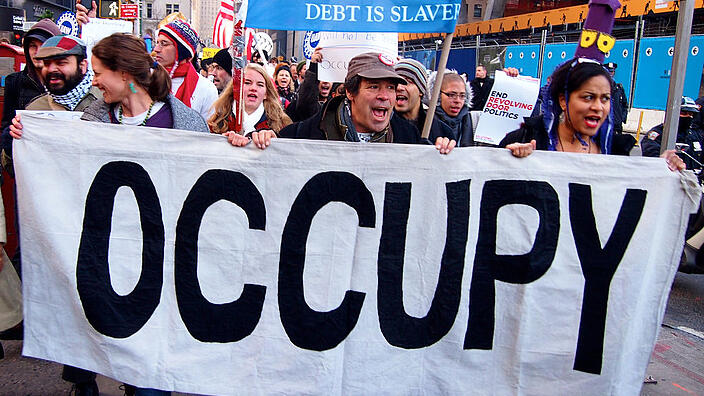 NEW YORK - DEC 12: Unidentified Occupy Wall Street protesters march to protest Goldman Sachs on December 12, 2011 in New York City, NY. Protests against the financial system took place nationwide.