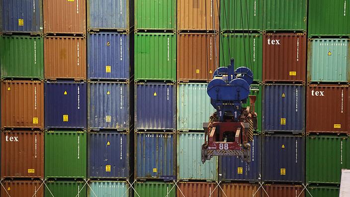 Stacked containers with transport vehicle in the front