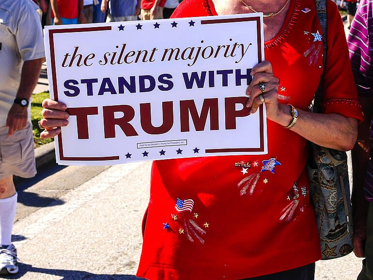 Donald Trump supporter holding pro-Trump poster