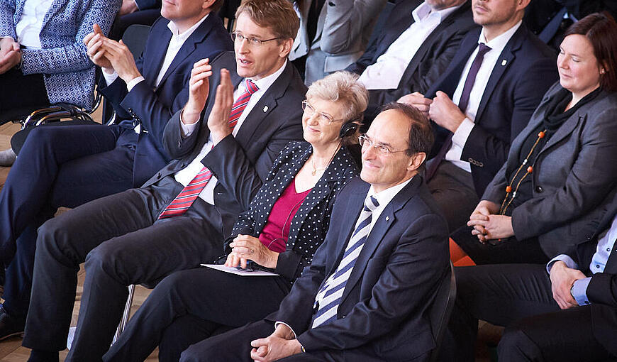 Judith und Dennis Snower neben Ministerpräsident Daniel Günther