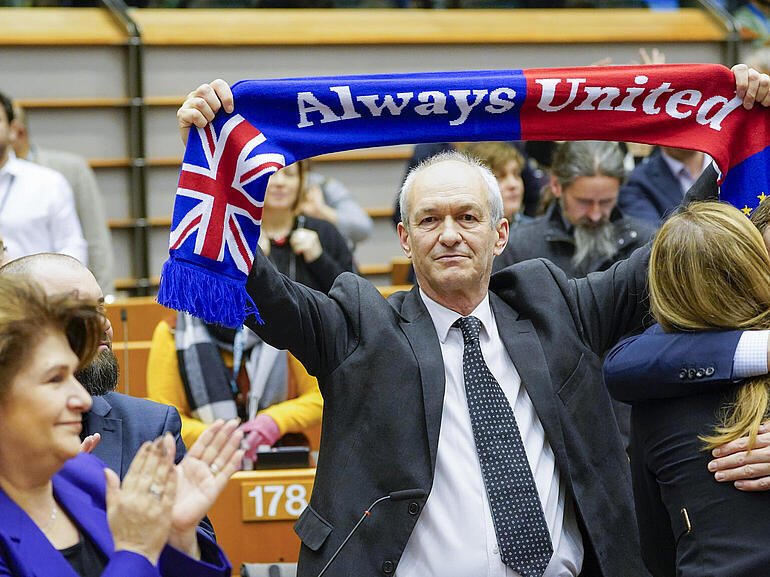 Man holding scarf with Union Jack and text "Always united"