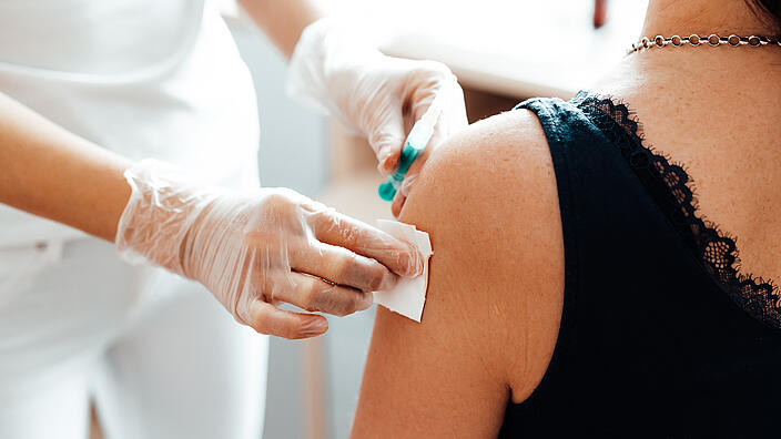 doctor vaccinating a patient against covid-19