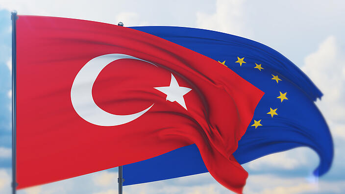 Waving European Union flag and flag of Turkey