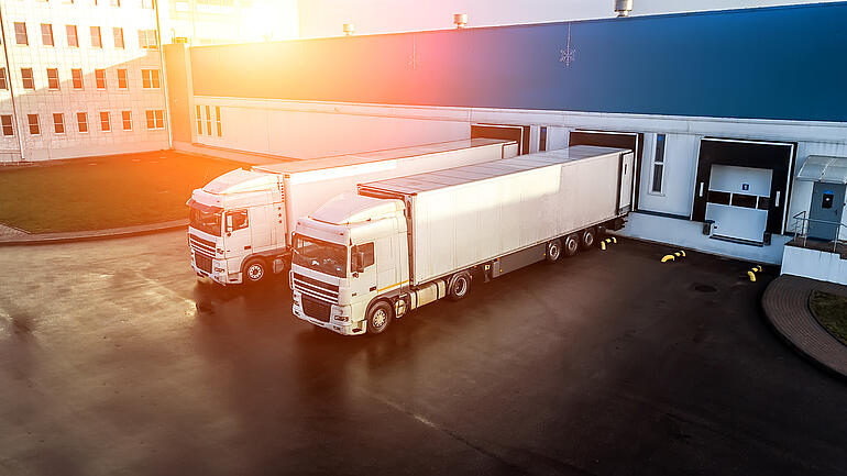 trucks are loaded in a modern logistics center