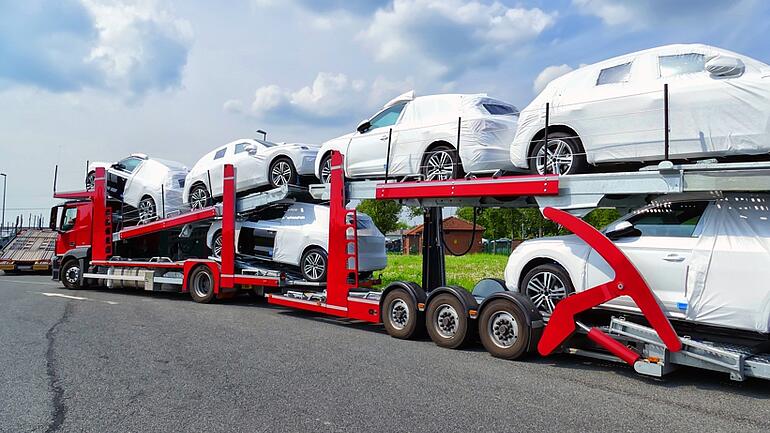 Transport of new cars wrapped in white foil