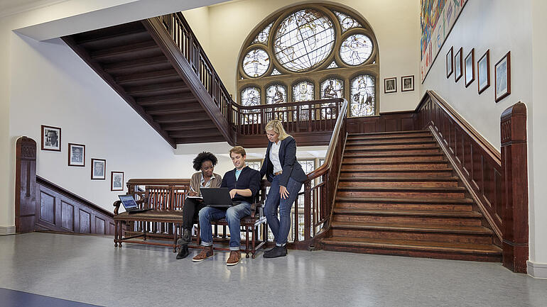 Students sitting on a bench in Kiel Institute´s hallway