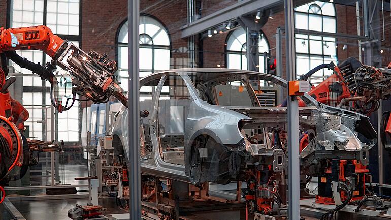 Car production line with robotic arms