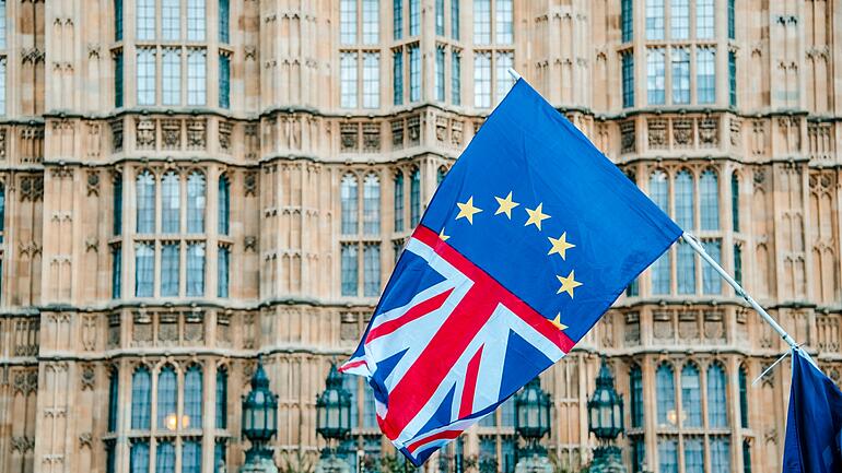 Half UK half EU flag in front of Houses of Parliament
